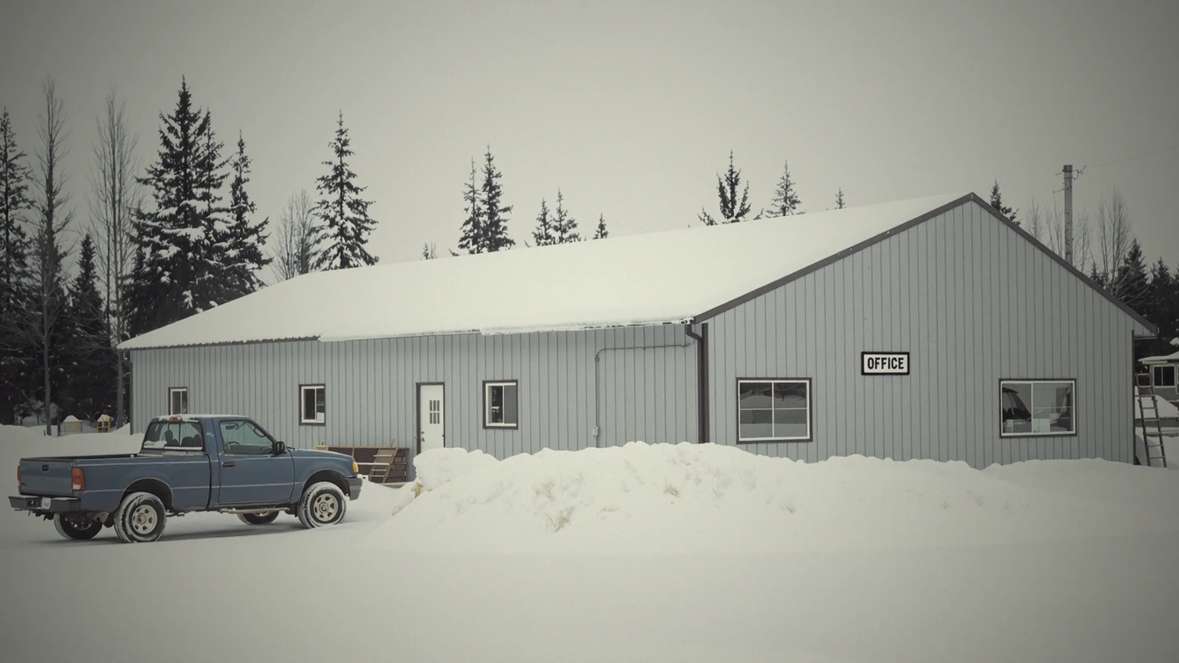 A service company's shop and office on a quiet morning, trucks parked out front